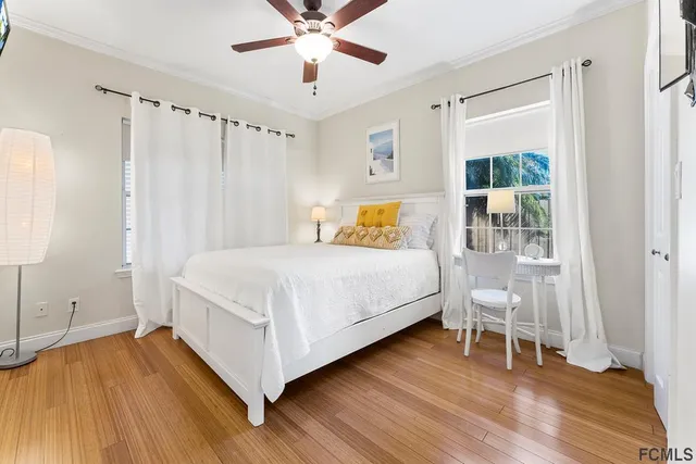 a bedroom with a bed and wooden floor