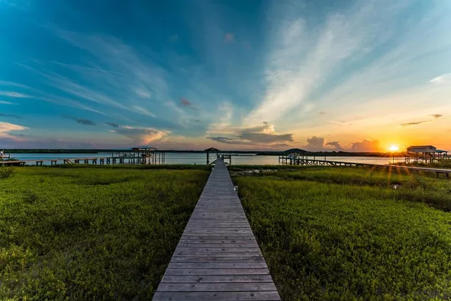a view of a pathway both side of grassy field
