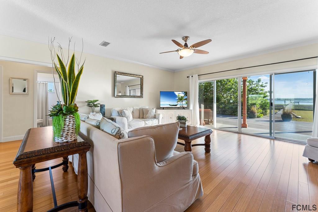 7619 A1A South St. Augustine, FL 32080 - Photo 10 of 51 a living room with furniture a potted plant and a large window