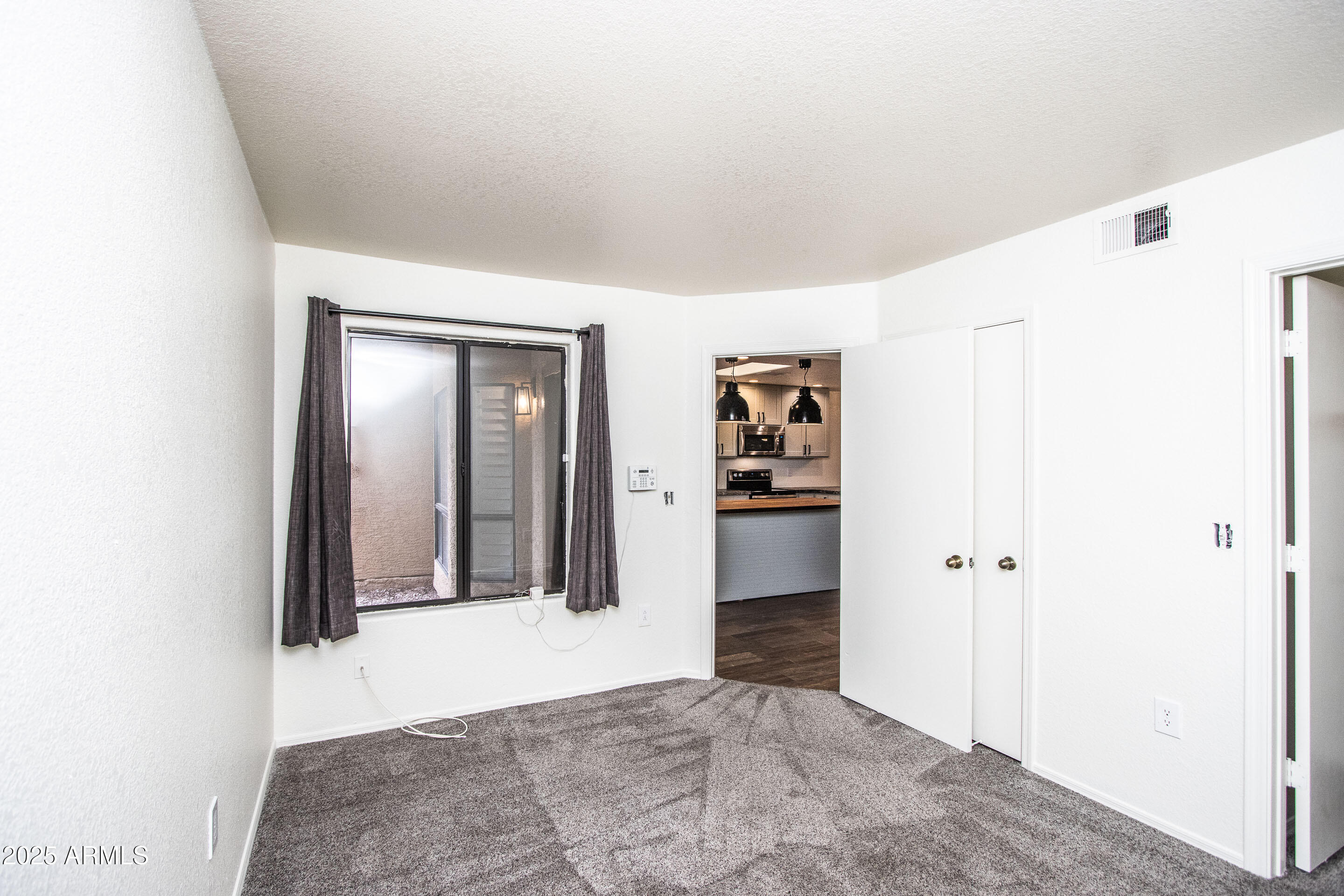 1318 East Cobb Drive Tempe, AZ 85288 - Photo 21 of 43 a view of a hallway with wooden shelves