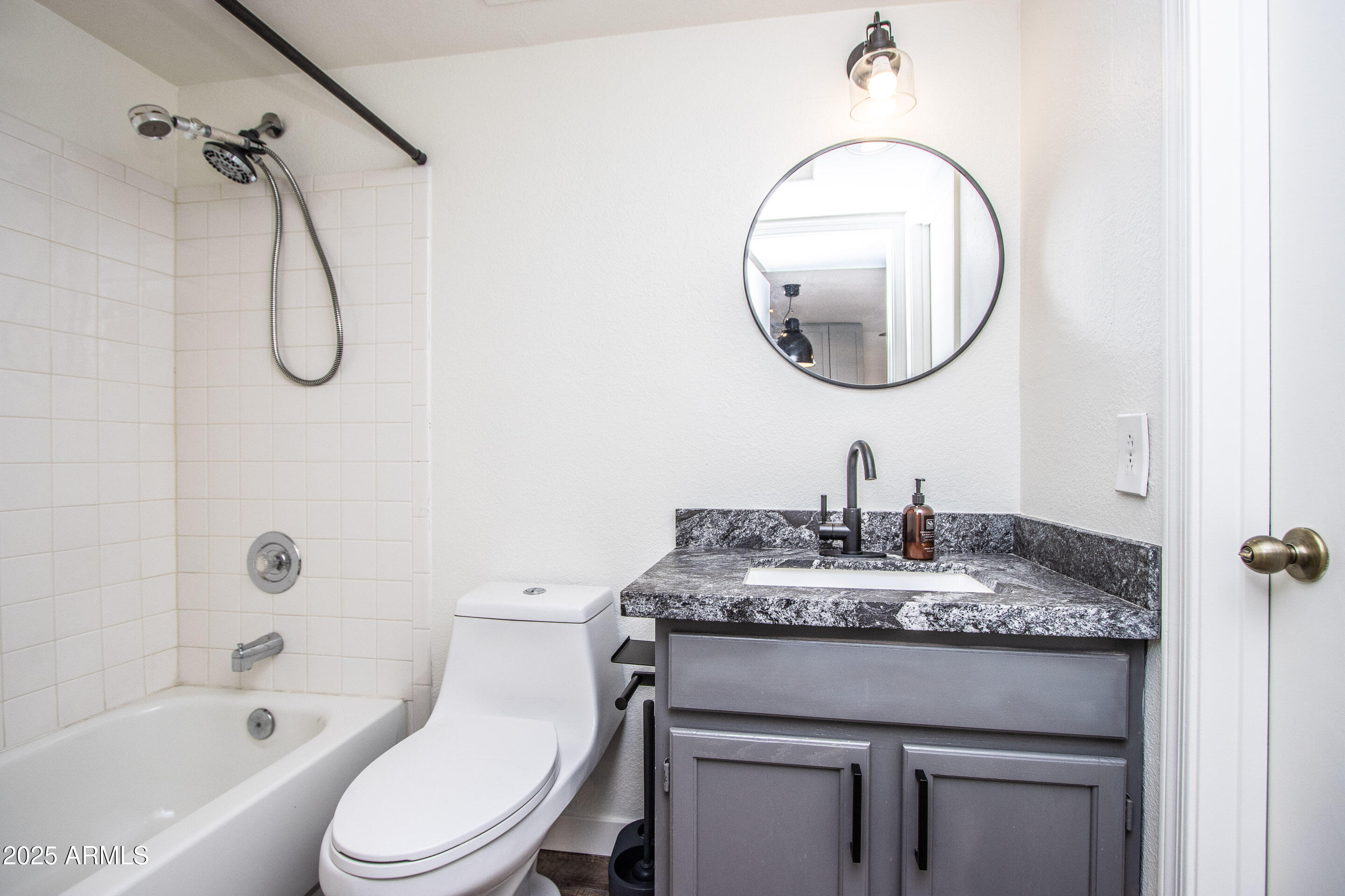 1318 East Cobb Drive Tempe, AZ 85288 - Photo 23 of 43 a bathroom with a granite countertop sink a toilet and a mirror