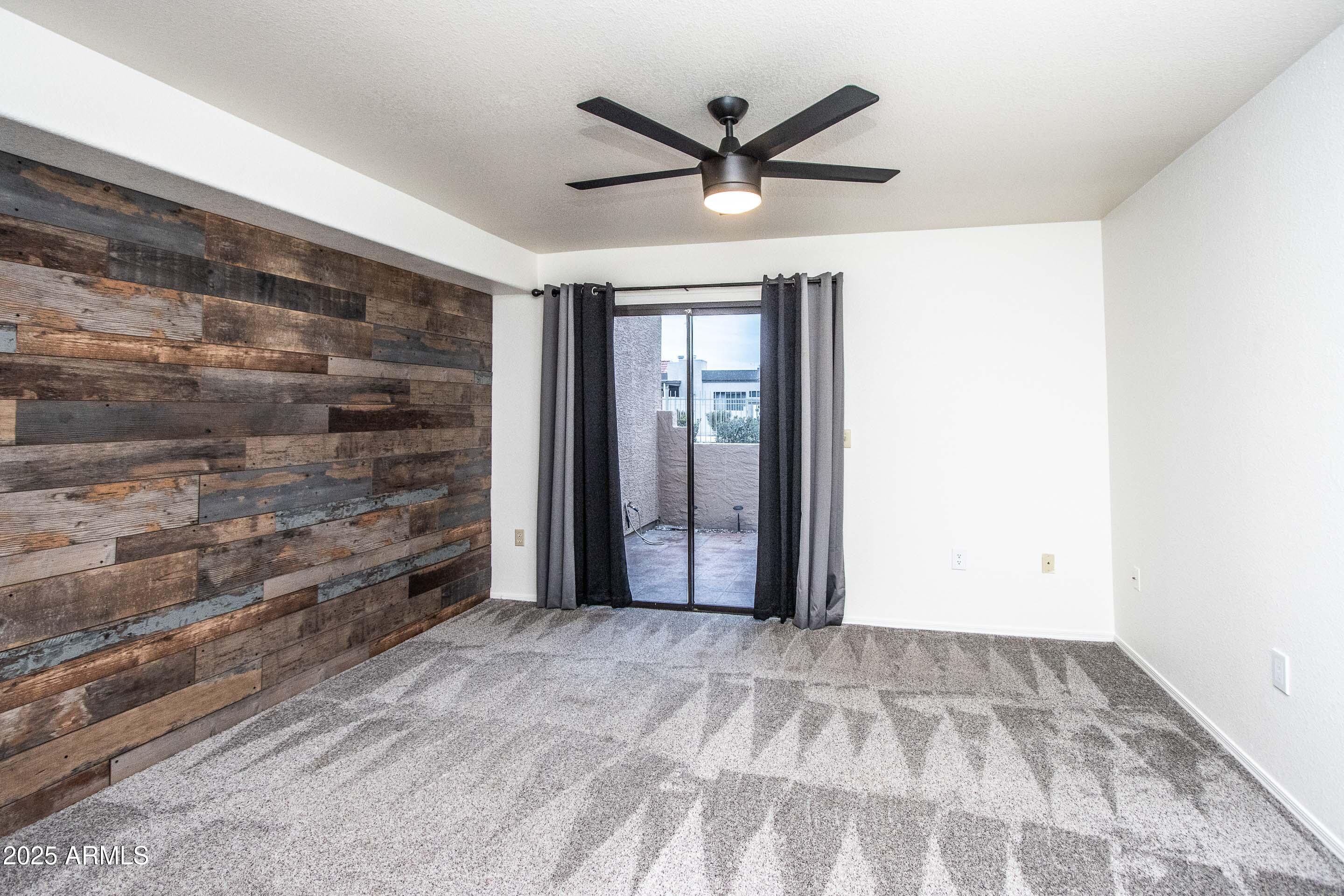 1318 East Cobb Drive Tempe, AZ 85288 - Photo 25 of 43 a view of empty room with wooden floor and ceiling fan