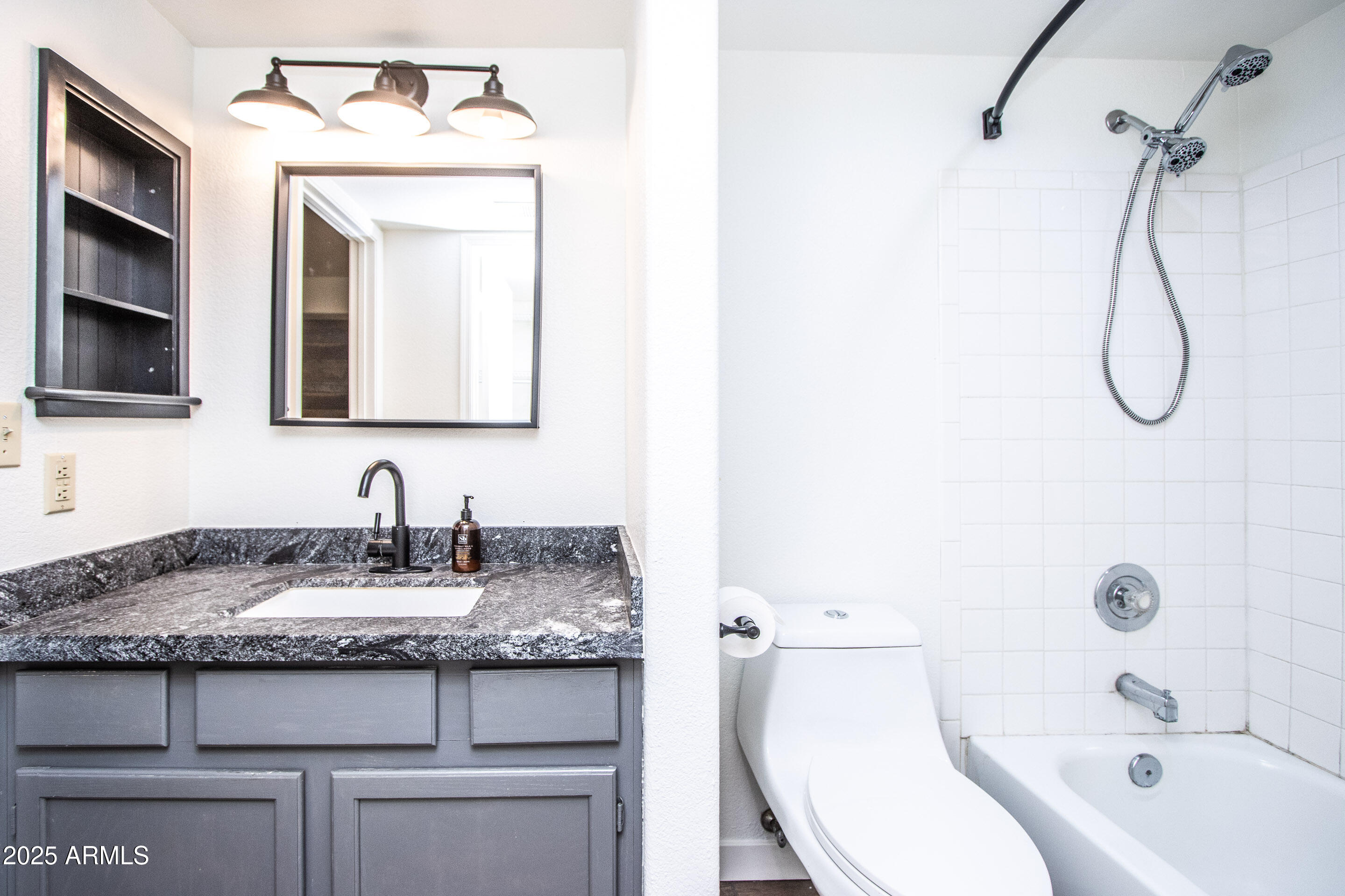 1318 East Cobb Drive Tempe, AZ 85288 - Photo 28 of 43 a bathroom with a granite countertop sink vanity mirror and bathtub