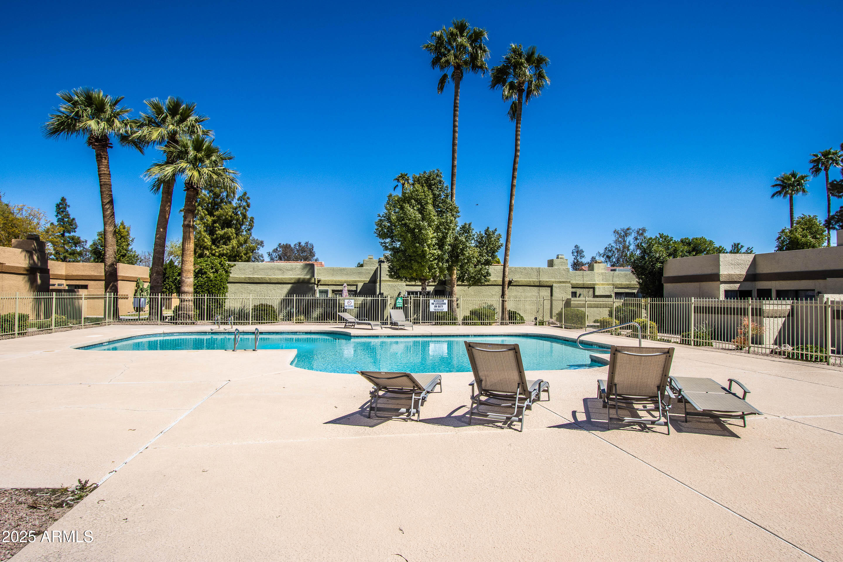 1318 East Cobb Drive Tempe, AZ 85288 - Photo 40 of 43 a view of a swimming pool with a table and chairs