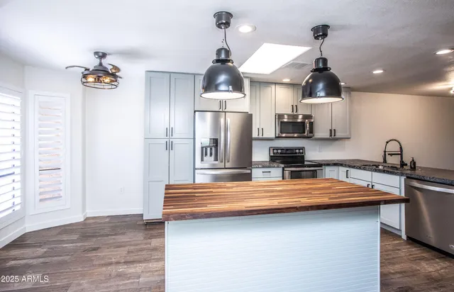 a kitchen with stainless steel appliances and cabinets