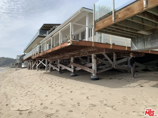 a view of a house with wooden deck
