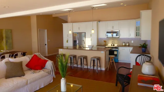 a living room with furniture and a dining table