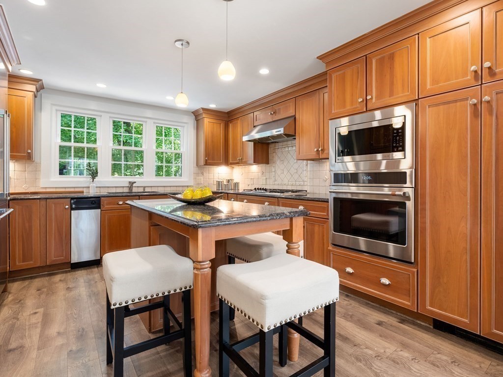 22 Howe Road Newton, MA 02459 - Photo 12 of 31 a kitchen with a stove a sink and a refrigerator