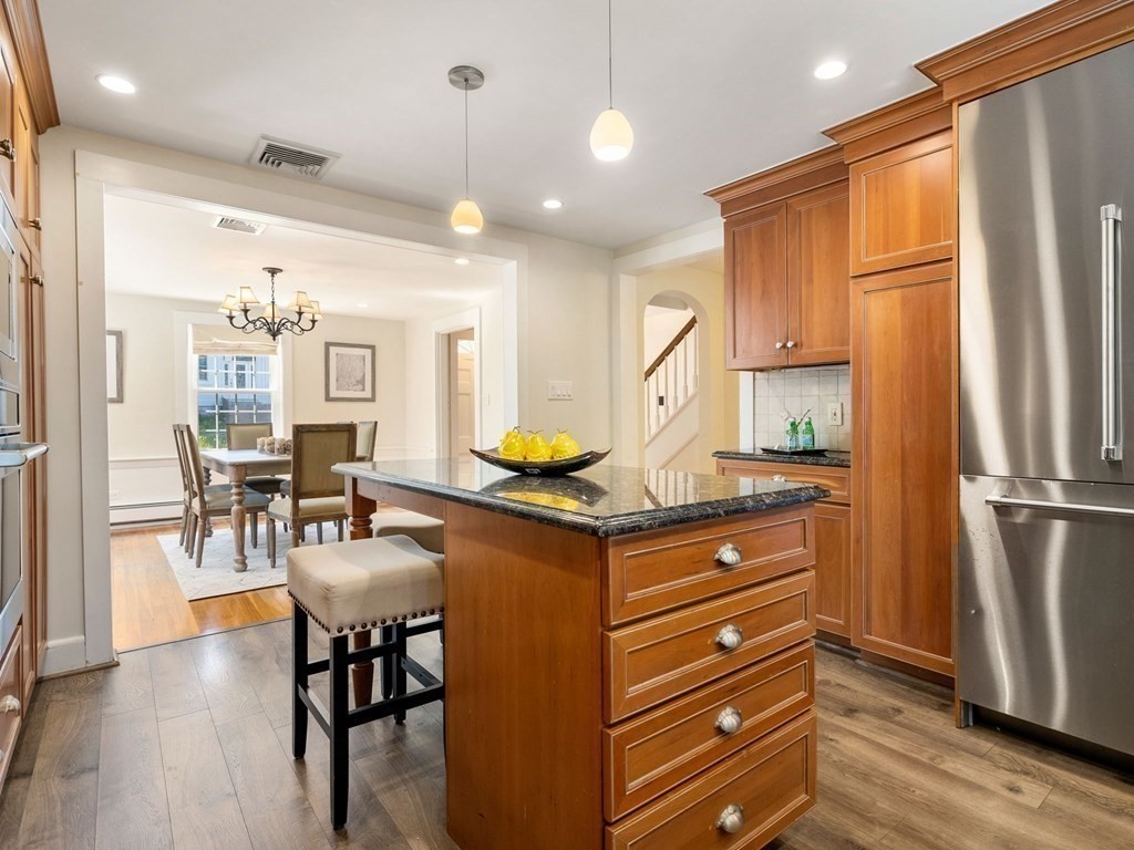 22 Howe Road Newton, MA 02459 - Photo 13 of 31 a kitchen with stainless steel appliances kitchen island granite countertop a refrigerator and a stove top oven