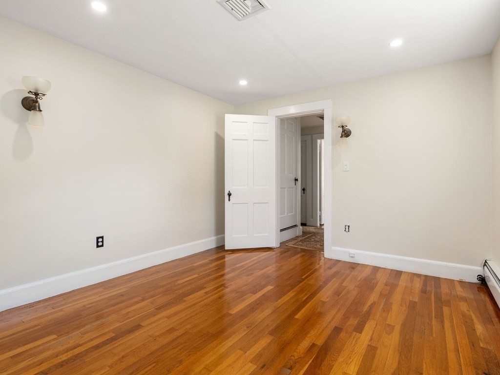 22 Howe Road Newton, MA 02459 - Photo 19 of 31 a view of an empty room with wooden floor and a ceiling fan