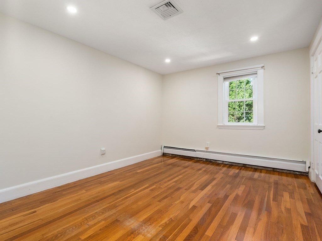 22 Howe Road Newton, MA 02459 - Photo 20 of 31 an empty room with wooden floor and windows