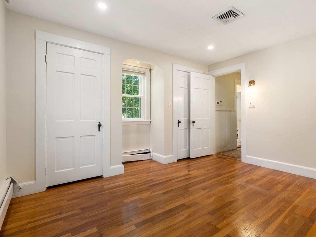 22 Howe Road Newton, MA 02459 - Photo 21 of 31 an empty room with wooden floor and windows