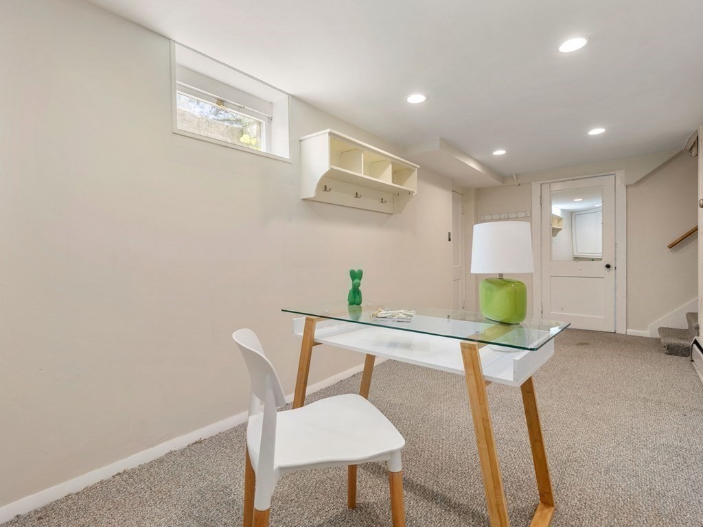 22 Howe Road Newton, MA 02459 - Photo 22 of 31 a workspace with furniture and a potted plant