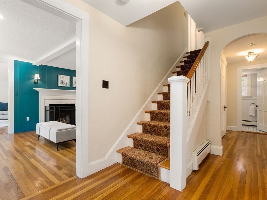 22 Howe Road Newton, MA 02459 - Photo 10 of 31 a view of a hallway with wooden floor and staircase