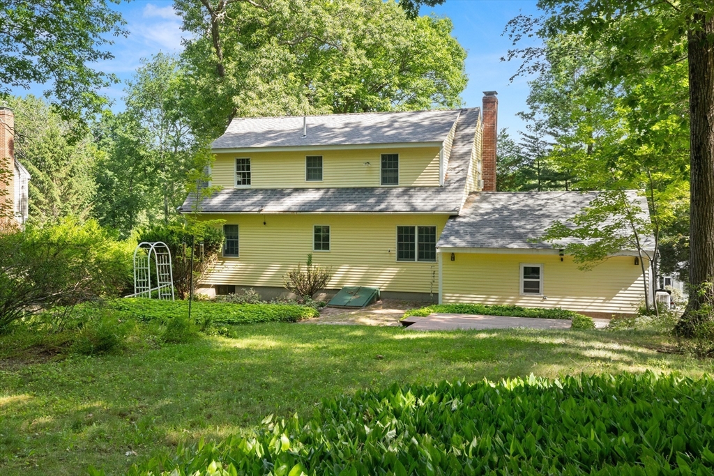 31 Kimball Road Amesbury, MA 01913 - Photo 34 of 40 a backyard of a house with table and chairs under an umbrella