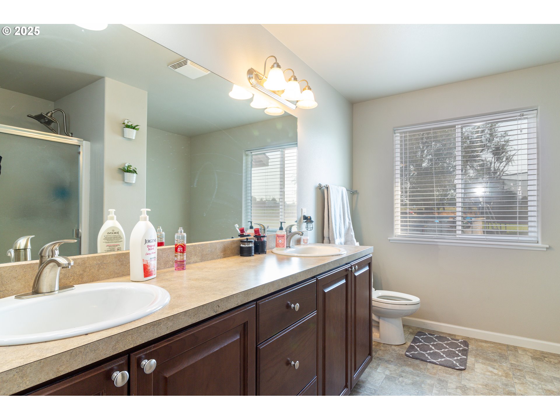 1815 Minnehaha Road Hermiston, OR 97838 - Photo 18 of 34 a bathroom with a granite countertop sink a toilet and a mirror