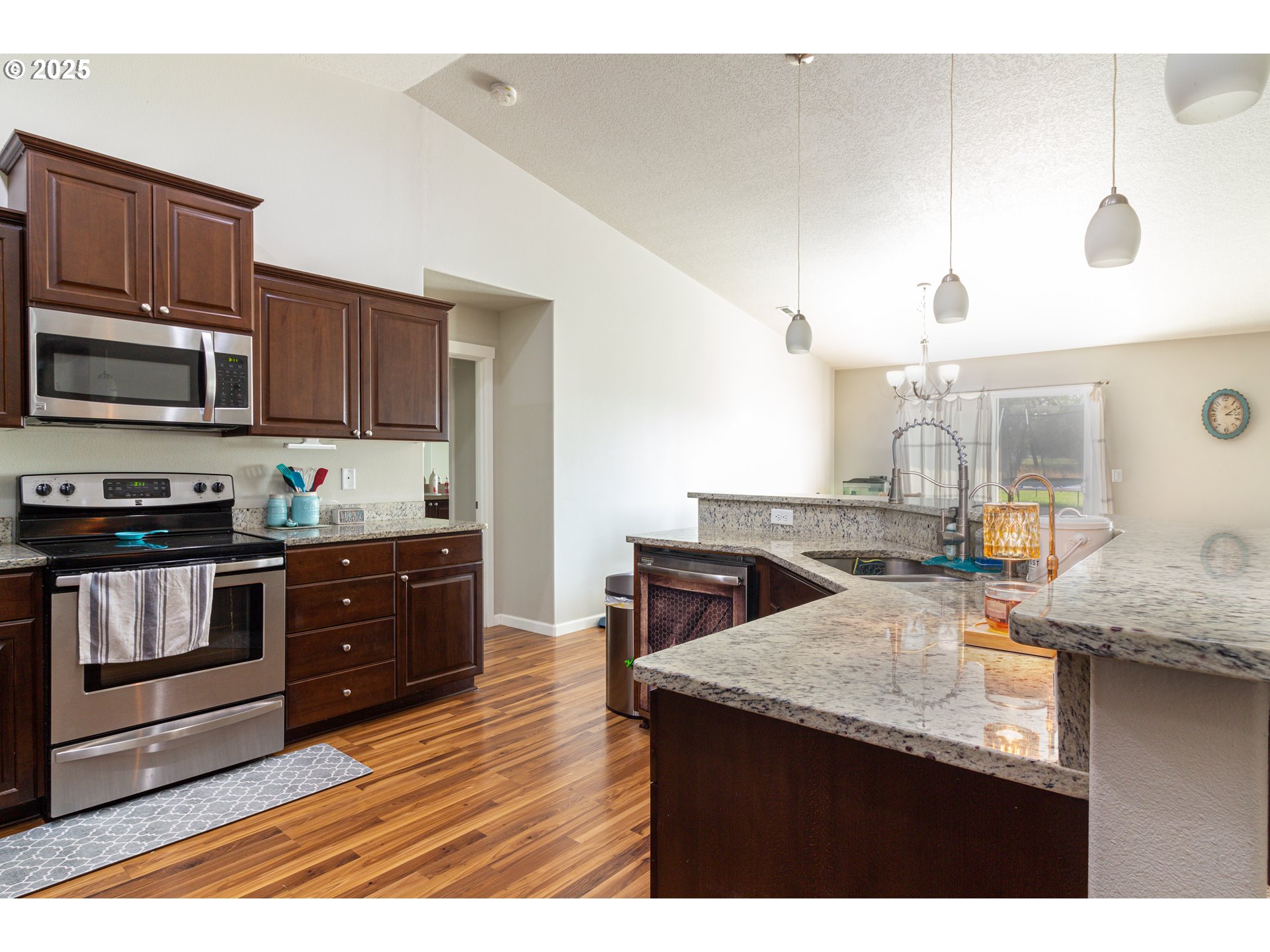 1815 Minnehaha Road Hermiston, OR 97838 - Photo 28 of 34 a kitchen with stainless steel appliances granite countertop a sink a stove and a microwave