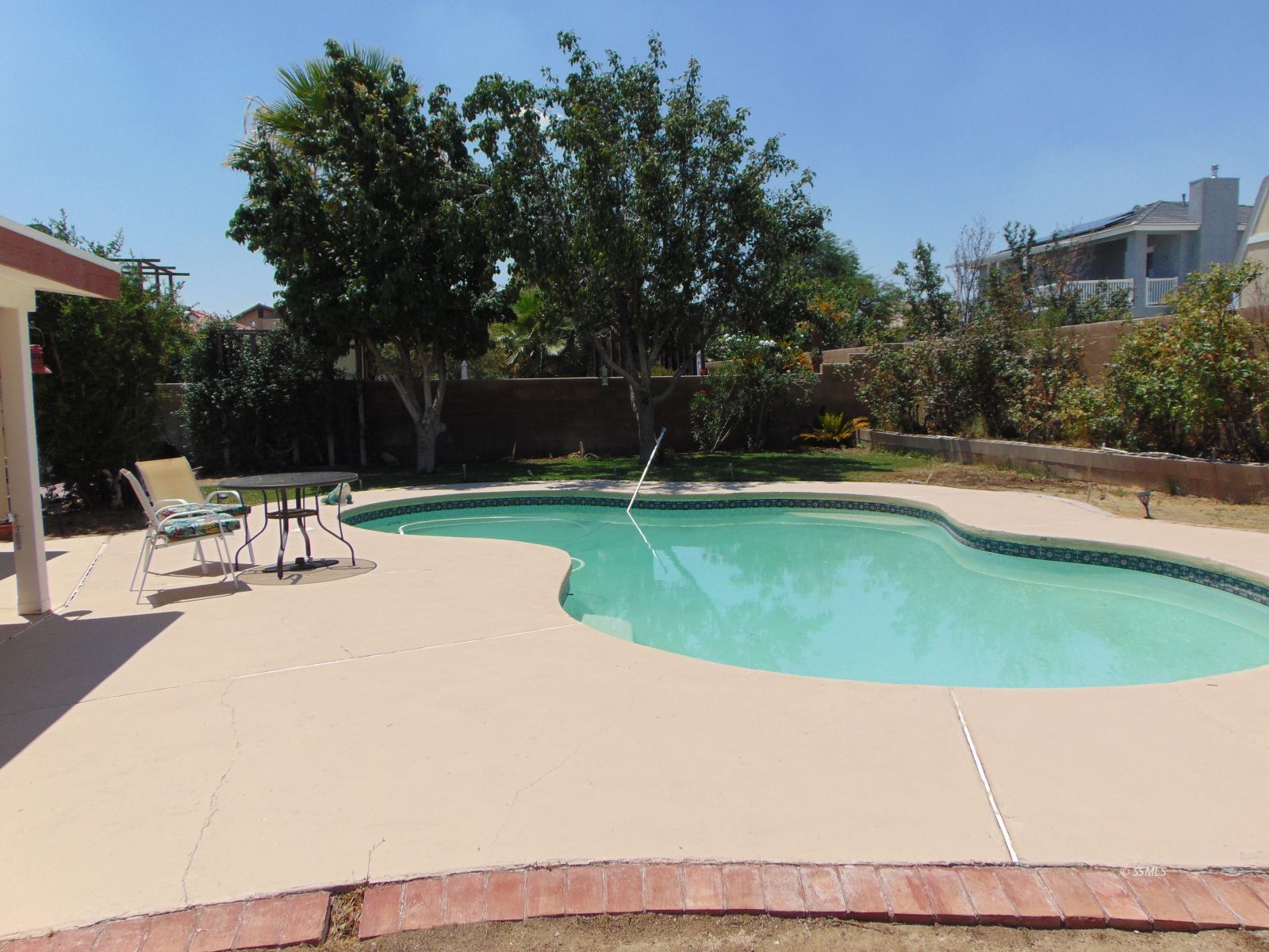 917 Carolyn Street Ridgecrest, CA 93555 - Photo 22 of 26 a view of a swimming pool with a yard