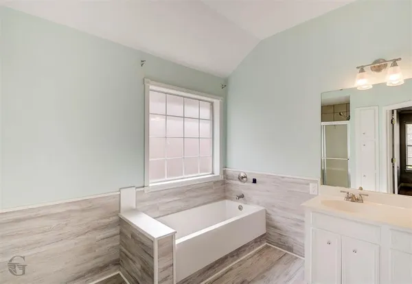 an empty room with a window and a chandelier