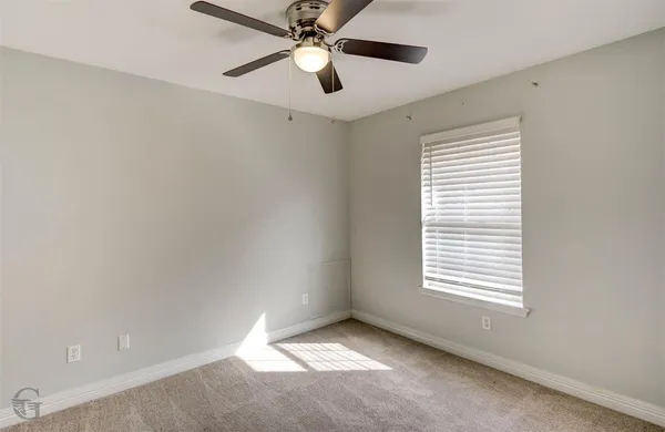 a view of backyard with wooden fence