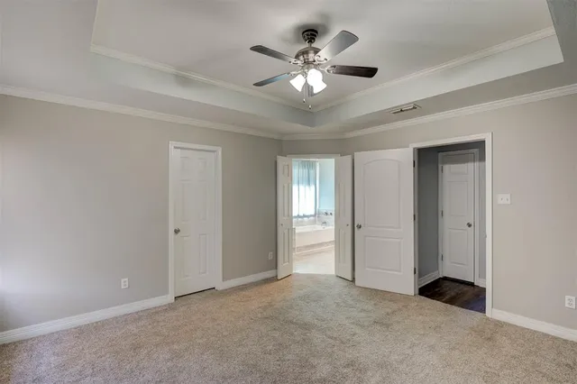 a view of an empty room with a ceiling fan