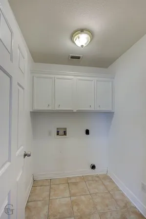 a view of a big room with chandelier fan