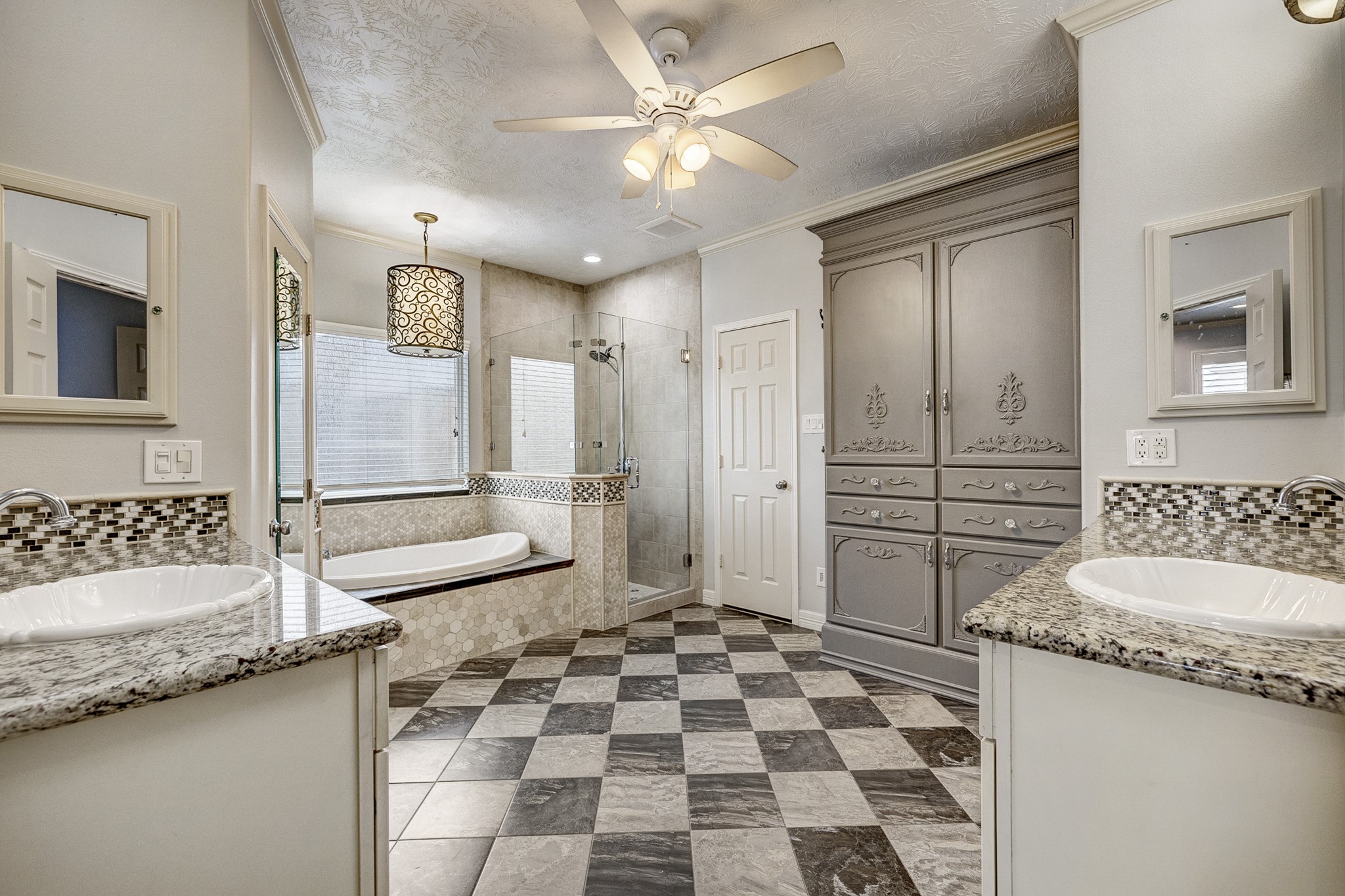 18606 Spring Heather Court Spring, TX 77379 - Photo 24 of 50 Spacious primary bathroom with double sinks, soaking tub and seamless glass shower with floor to ceiling tile.