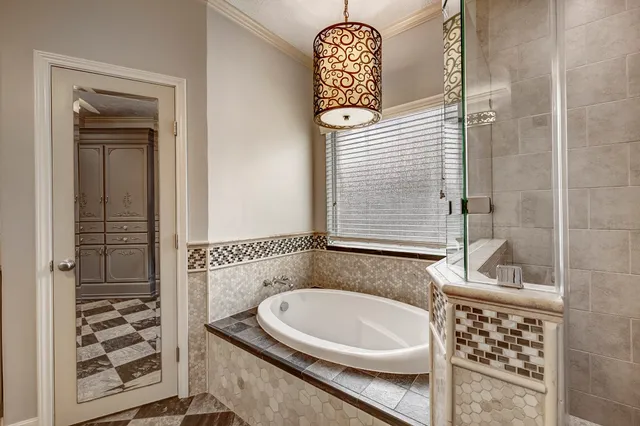 a view of a livingroom with a chandelier fan and wooden floor
