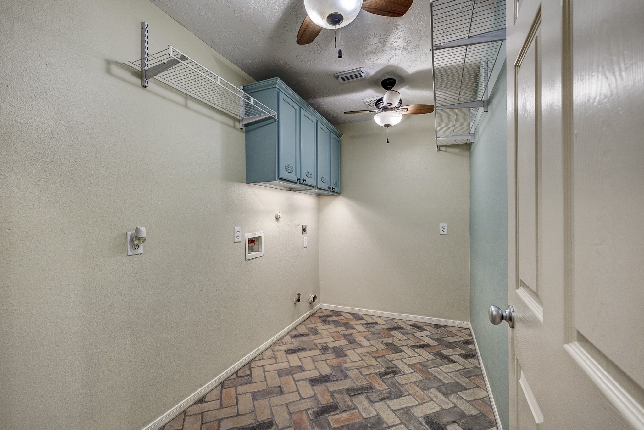 18606 Spring Heather Court Spring, TX 77379 - Photo 30 of 50 Utility room in the home with ceiling fans, brick flooring, storage cabinets and hanging space