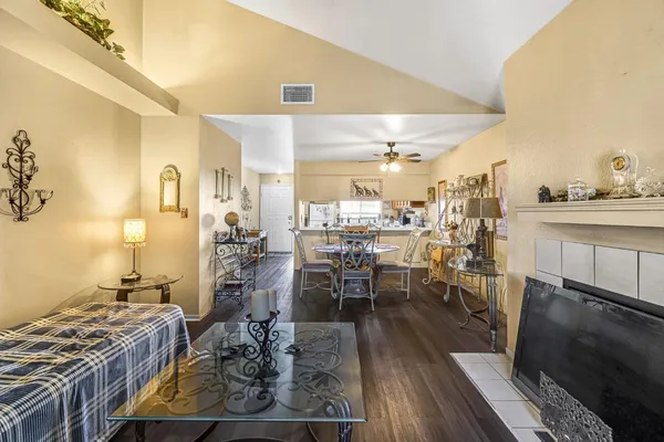 a view of a dining room with furniture a kitchen and chandelier