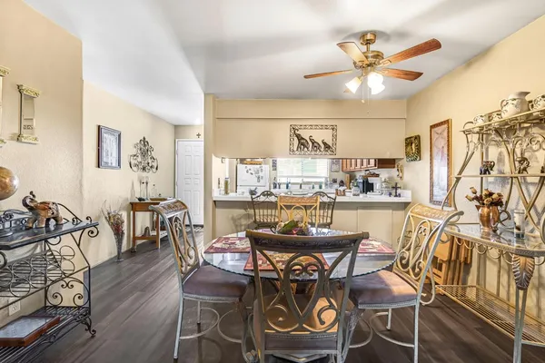 a very nice looking dining room with furniture and a large window
