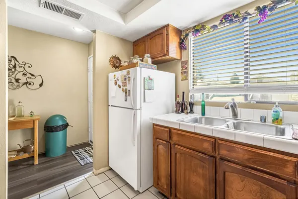 a kitchen with stainless steel appliances granite countertop a sink a stove and cabinets