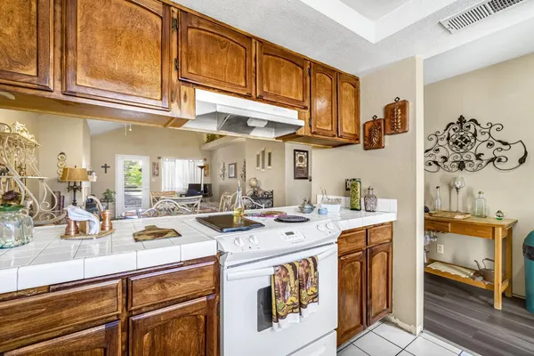 a bathroom with a granite countertop sink a mirror and a shower