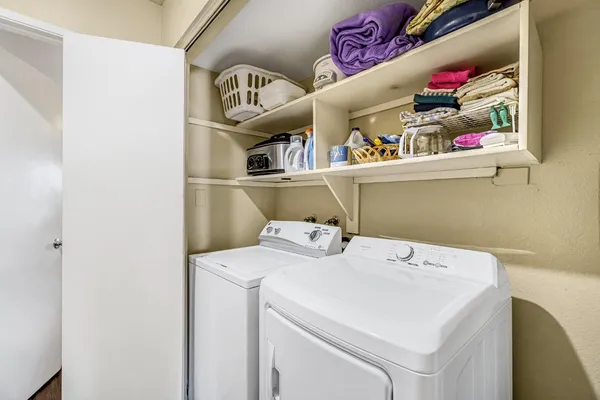 a bedroom with a bed and a flat tv screen on dresser