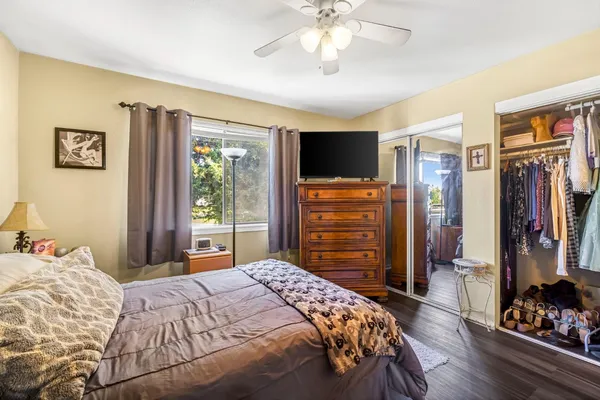 a bedroom with a bed and a refrigerator