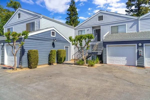 a view of a house with porch and a garage