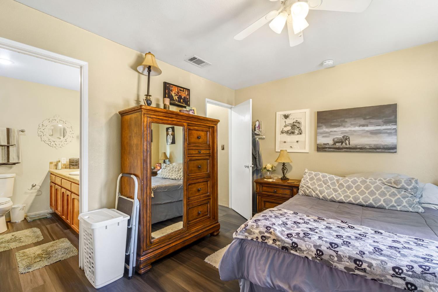 7675 North First Street, Unit 202 Fresno, CA 93720 - Photo 21 of 24 a bedroom with a bed and a refrigerator