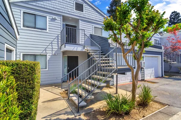 a view of a patio with table and chairs and potted plants