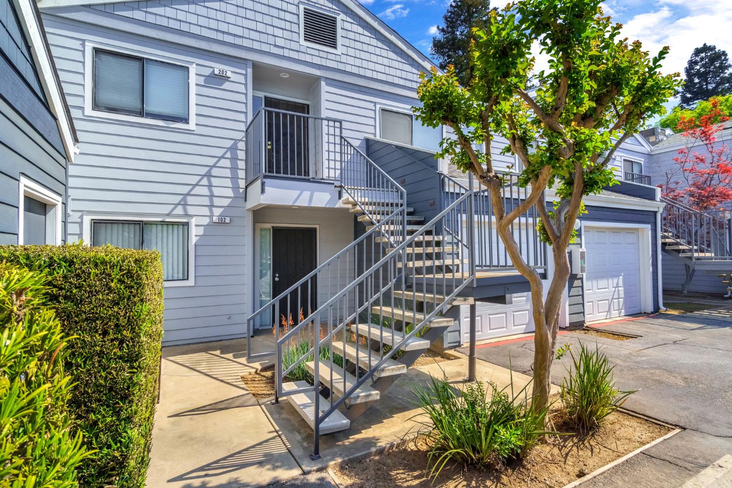 7675 North First Street, Unit 202 Fresno, CA 93720 - Photo 3 of 24 a view of a patio with table and chairs and potted plants