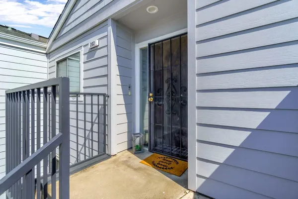 a view of a hallway with wooden floor and a dining table