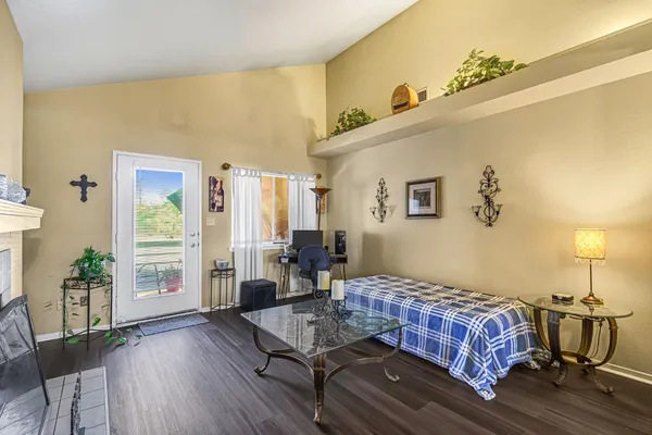 a living room with furniture a fireplace and a floor to ceiling window