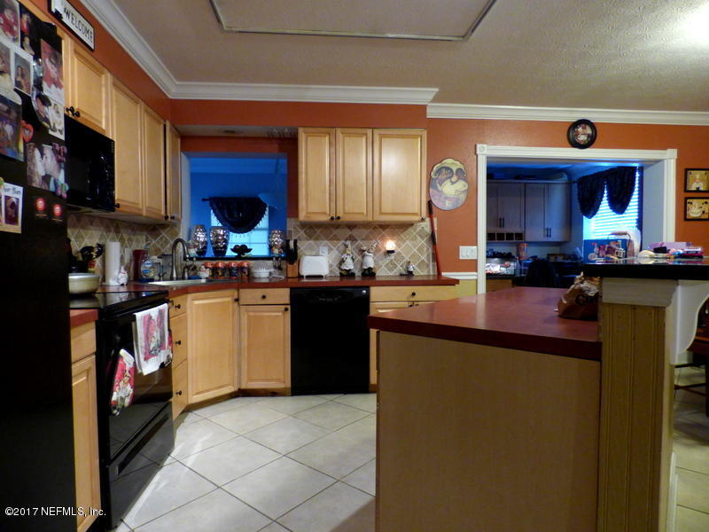 299 Capella Road Orange Park, FL 32073 - Photo 6 of 26 a kitchen with a sink cabinets and window