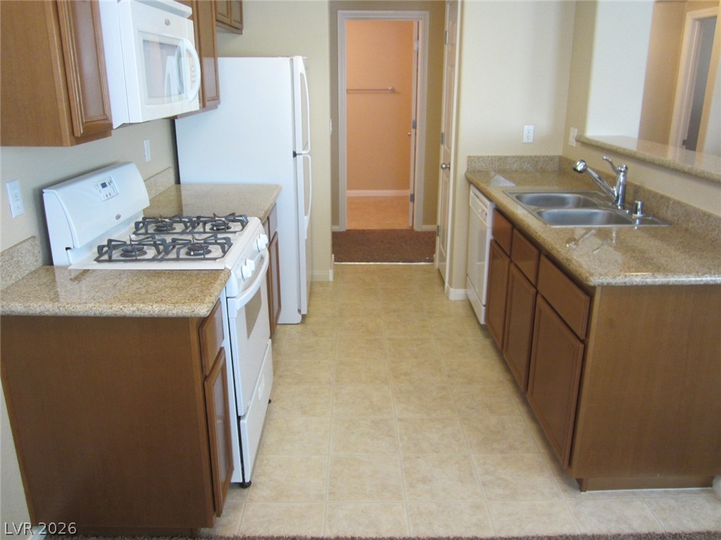 7701 West Robindale Road, Unit 262 Las Vegas, NV 89113 - Photo 10 of 26 A well-appointed kitchen features ample cabinetry and durable countertops for everyday living.