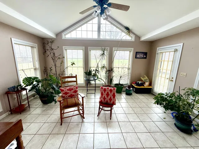 a living room with patio furniture and a large window