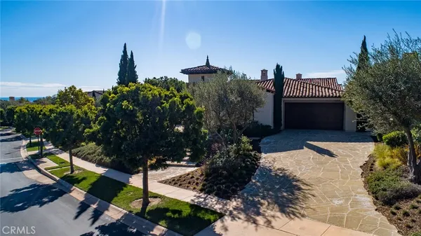an aerial view of a house with swimming pool and a yard