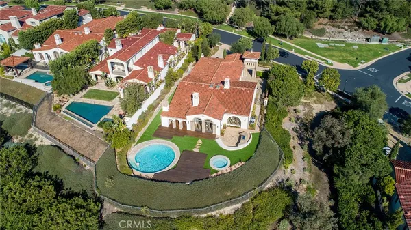 an aerial view of a house with swimming pool garden and patio