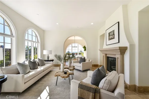 a living room with furniture fireplace and a large window