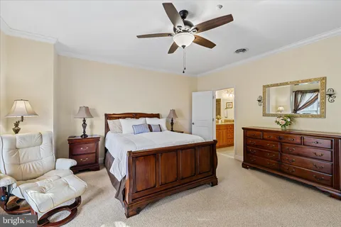 a living room with furniture and a ceiling fan