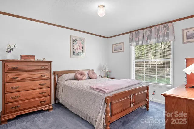 a bed room with a bed and a window