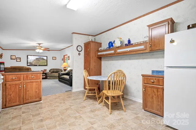 a living room with furniture a refrigerator a sink a stove and a refrigerator